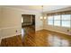 Elegant dining room with hardwood floors and a chandelier, perfect for Gathering dinners and entertaining at 16612 Grapperhall Dr, Huntersville, NC 28078
