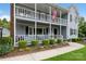 Charming two-story home featuring a covered double porch and colorful flower beds, adding to its appeal at 16612 Grapperhall Dr, Huntersville, NC 28078