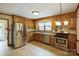 Well-equipped kitchen with stainless steel appliances, granite countertops, and wood cabinetry at 16612 Grapperhall Dr, Huntersville, NC 28078