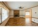 Bright living room featuring hardwood floors, a brick fireplace, and large windows, creating a warm atmosphere at 16612 Grapperhall Dr, Huntersville, NC 28078