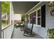 Cozy front porch with rocking chairs and a bench, perfect for enjoying the outdoors at 16612 Grapperhall Dr, Huntersville, NC 28078