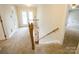 Carpeted stairs with wood railing at 16612 Grapperhall Dr, Huntersville, NC 28078