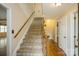 Carpeted stairs with a wooden banister lead to the upper level at 16612 Grapperhall Dr, Huntersville, NC 28078