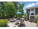 Landscaped backyard featuring a fire pit, outdoor seating, and a well-maintained lawn at 16831 Alydar Commons Ln, Charlotte, NC 28278