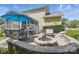 Backyard with a stone firepit, patio furniture, grill, and partially-screened outdoor living area at 16831 Alydar Commons Ln, Charlotte, NC 28278