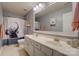 Neutral bathroom featuring a double vanity, modern fixtures and a shower with an elephant shower curtain at 16831 Alydar Commons Ln, Charlotte, NC 28278