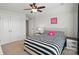 Cozy bedroom with a striped comforter, a plush decorative pillow, and neutral-toned walls at 16831 Alydar Commons Ln, Charlotte, NC 28278