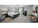Comfortable bedroom featuring a ceiling fan, neutral carpet, and good natural light at 16831 Alydar Commons Ln, Charlotte, NC 28278