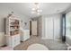 Neutral-toned ' bedroom with modern lighting, a white rug and carpeted floor at 16831 Alydar Commons Ln, Charlotte, NC 28278