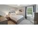 Cozy bedroom with a plush bed, soft lighting, and a window with nature views at 16831 Alydar Commons Ln, Charlotte, NC 28278