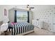 Bright bedroom featuring a striped bedspread, white dresser, and a window with neighborhood views at 16831 Alydar Commons Ln, Charlotte, NC 28278