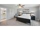 Comfortable bedroom featuring a ceiling fan, neutral carpet, and good natural light at 16831 Alydar Commons Ln, Charlotte, NC 28278