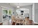 Bright dining room featuring wood floors, deck access, and an open view to the living room at 16831 Alydar Commons Ln, Charlotte, NC 28278