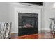 Close-up of the modern fireplace with black tile surround and a decorative mantel in the living room at 16831 Alydar Commons Ln, Charlotte, NC 28278