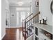 Elegant foyer with hardwood floors, a staircase with wrought iron railings, and plenty of natural light at 16831 Alydar Commons Ln, Charlotte, NC 28278