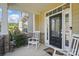 Inviting front porch with rocking chairs and a decorative front door with glass panels at 16831 Alydar Commons Ln, Charlotte, NC 28278