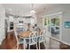 Bright kitchen featuring white cabinets, stainless steel appliances, and an adjacent dining area at 16831 Alydar Commons Ln, Charlotte, NC 28278