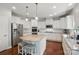 Gourmet kitchen with stainless steel appliances, granite countertops, and a center island with seating at 16831 Alydar Commons Ln, Charlotte, NC 28278