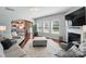 Open-concept living room with hardwood floors, large windows, and a view into the dining area at 16831 Alydar Commons Ln, Charlotte, NC 28278