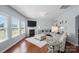 Cozy living room featuring a fireplace, large windows, and stylish furniture arrangement at 16831 Alydar Commons Ln, Charlotte, NC 28278