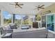 Cozy screened porch with seating, mounted TV, and access to backyard at 16831 Alydar Commons Ln, Charlotte, NC 28278