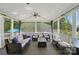 Screened-in porch with comfortable seating, ceiling fans, and a view of the outdoors at 16831 Alydar Commons Ln, Charlotte, NC 28278