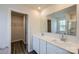 Well-lit bathroom featuring double sinks, modern fixtures, a walk-in closet, and a large mirror at 1711 Wooten Way, Bessemer City, NC 28016