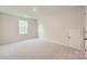 An empty bedroom offers neutral walls and carpet along with a window for natural light at 1711 Wooten Way, Bessemer City, NC 28016