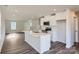 Open-concept kitchen with white cabinets, stainless appliances, and a spacious island perfect for entertaining at 1711 Wooten Way, Bessemer City, NC 28016