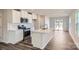 Modern kitchen features white cabinets, stainless steel appliances, and a stylish central island at 1711 Wooten Way, Bessemer City, NC 28016