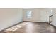 Bright living room features sleek hardwood floors, a front door, and plenty of natural light at 1711 Wooten Way, Bessemer City, NC 28016
