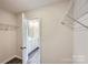 Spacious walk-in closet with ample shelving and easy access to the ensuite bathroom and bedroom at 1711 Wooten Way, Bessemer City, NC 28016