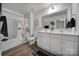 Bright bathroom with a double sink vanity, framed mirror, and shower-tub combination at 177 Briana Marie Way, Indian Trail, NC 28079