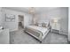 Bright bedroom features soft carpet, an elegant chandelier, and a comfortable bed at 177 Briana Marie Way, Indian Trail, NC 28079