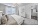 Inviting bedroom with large windows, a gold light fixture, and an adjoining bathroom at 177 Briana Marie Way, Indian Trail, NC 28079