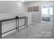 Well-lit hallway featuring neutral walls, plush gray carpeting, and a view into the bedroom at 177 Briana Marie Way, Indian Trail, NC 28079