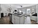 An open-concept kitchen featuring granite countertops, stainless steel appliances, and views into the living room at 177 Briana Marie Way, Indian Trail, NC 28079