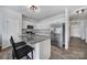 A modern kitchen with granite countertops, stainless steel appliances, and a breakfast bar with seating for two at 177 Briana Marie Way, Indian Trail, NC 28079