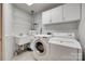 Well-lit laundry room with washer, dryer, utility sink and lots of shelving at 1866 Charter Dr, Rock Hill, SC 29732
