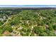 An aerial view showcases the house nestled within lush, mature trees and green landscape at 1940 12Th Ne St, Hickory, NC 28601