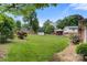 Spacious backyard with a mix of green lawn, mature trees, and privacy fence at 1940 12Th Ne St, Hickory, NC 28601