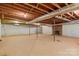 Spacious unfinished basement with a brick fireplace and support beams, ready for customization at 1940 12Th Ne St, Hickory, NC 28601