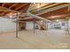 Unfinished basement with exposed wooden beams, brick fireplace, and concrete floor offering customization potential at 1940 12Th Ne St, Hickory, NC 28601