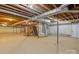 Unfinished basement featuring exposed duct work and wooden stairway at 1940 12Th Ne St, Hickory, NC 28601