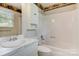 Bathroom with a vanity and shower-tub combination with neutral-colored walls at 1940 12Th Ne St, Hickory, NC 28601