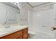 Traditional bathroom featuring patterned wallpaper, a vanity sink, and a shower-tub combination at 1940 12Th Ne St, Hickory, NC 28601