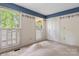 Bedroom offers large windows, closet space, and neutral-colored carpet at 1940 12Th Ne St, Hickory, NC 28601