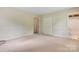 Bedroom features neutral paint and carpet, along with a closet and an attached bathroom at 1940 12Th Ne St, Hickory, NC 28601
