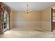 Bright and airy dining room with neutral carpet and classic chandelier at 1940 12Th Ne St, Hickory, NC 28601