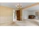 Dining room with beige walls adjacent to a kitchen with white appliances and an additional room with a piano at 1940 12Th Ne St, Hickory, NC 28601